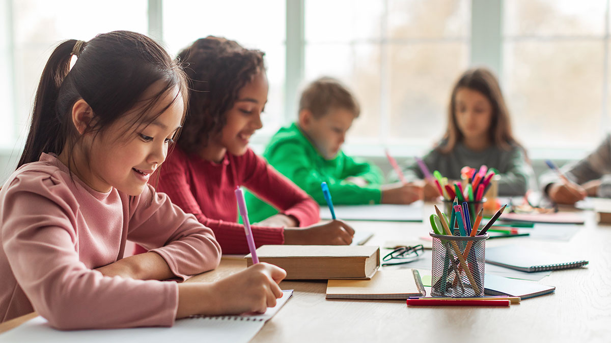 students sitting in class doing homework